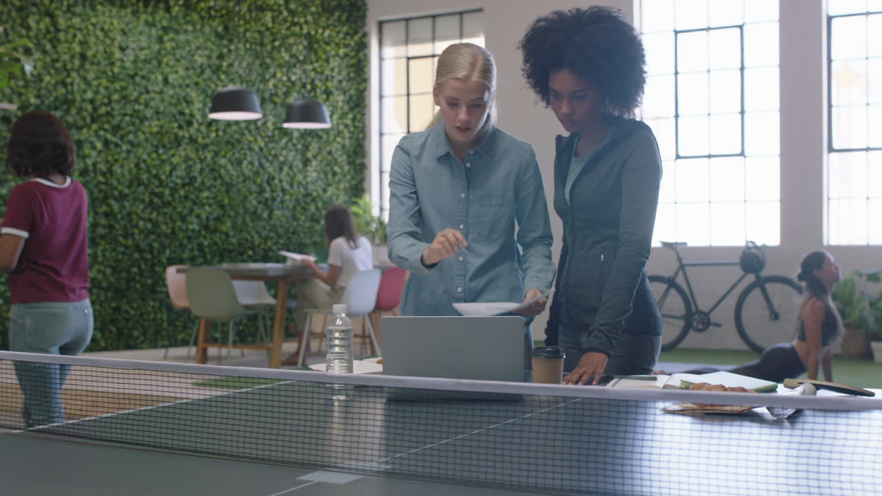 young business women brainstorming working together sharing ideas collaborating on project enjoying teamwork in modern office workplace