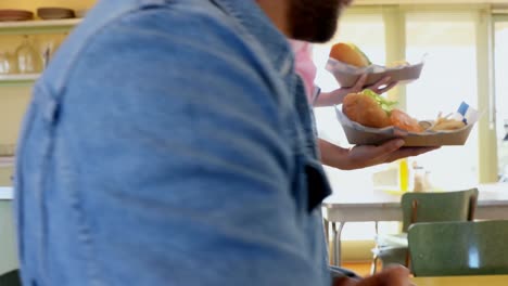 waitress serving meal to man in restaurant 4k