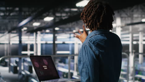 technician in data center stressed by critical error popup on laptop