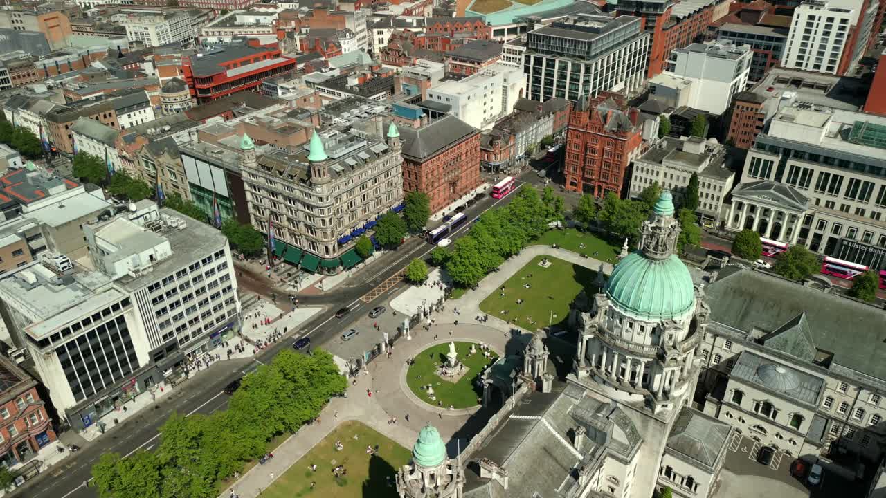 Side-on aerial video of Belfast City Hall in Belfast, Northern Ireland, UK on a bright and sunny day. Filmed in 4K, 60FPS and with Rec709 Color.