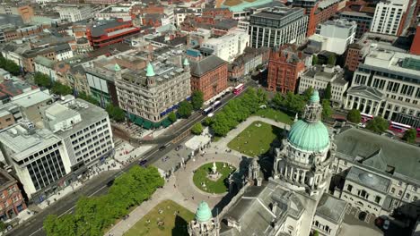 side-on aerial video of belfast city hall in belfast, northern ireland, uk on a bright and sunny day. filmed in 4k, 60fps and with rec709 color.