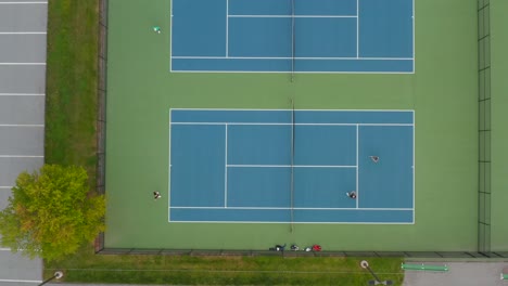 aerial of people playing doubles tennis on court