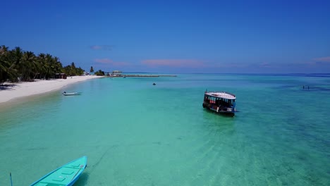 aerial-footage,-zooming-in-on-a-sightseeing-boat-on-the-Caribbean-sea