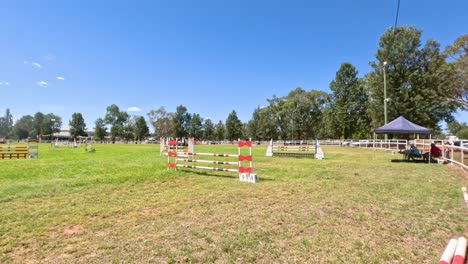 empty horse racetrack with jumps and grass field