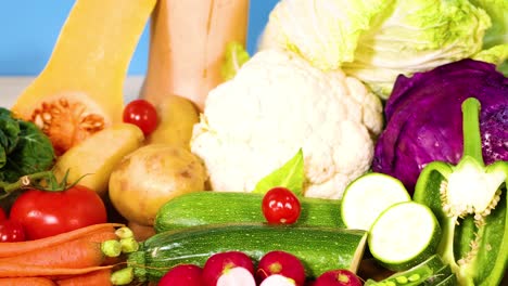 assorted vegetables displayed against a blue backdrop