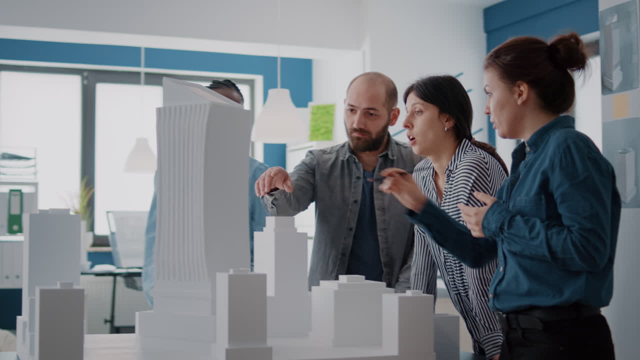 Architects collaborating on a building model in the office