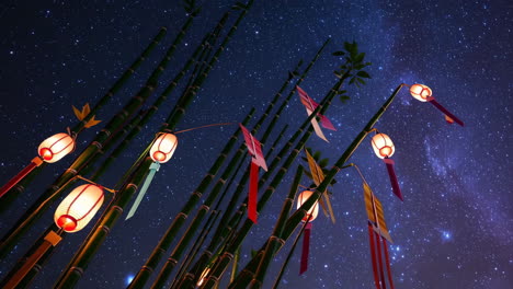 bamboo lanterns and flags under a starry night sky