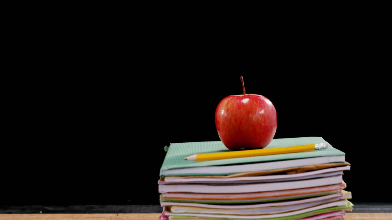 Red apple on book stack