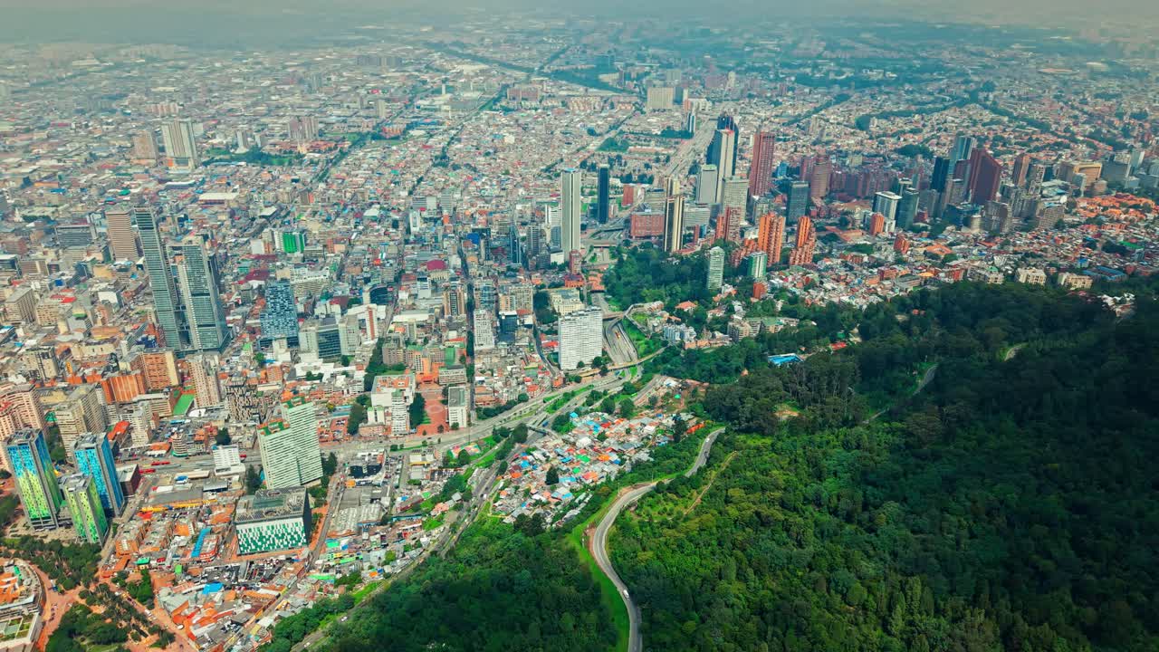 Panoramic drone shot overlooking the Bogota city skyline, from the mountains