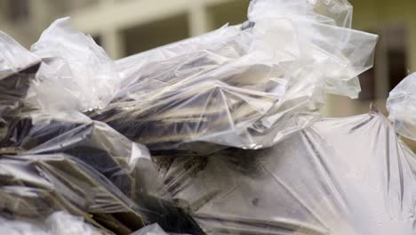 pieces of asbestos material in plastic bags piled up