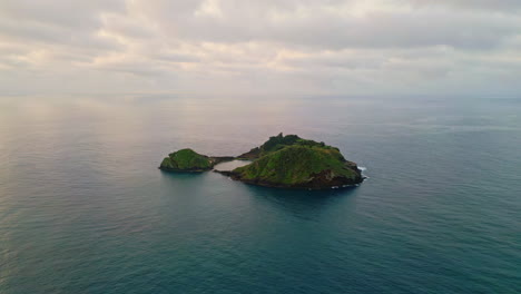 aerial tropical island washing by atlantic ocean water. endless marine landscape