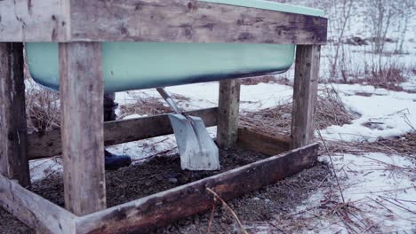 the man is distributing gravel beneath the diy hot tub - static shot