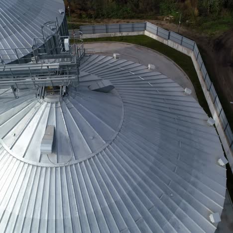 metal constructions on the top of grain elevators. modern industry for storage agricultural products. silver granaries for agribusiness. top aerial view