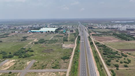 panoramic view of factories and smokestacks with a hazy skyline in hyderabad.