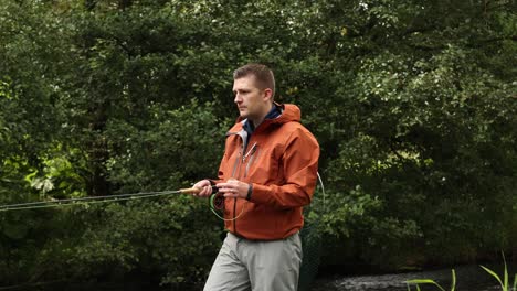 Hand-held-shot-of-a-flyfisherman-following-his-lures-along-the-river