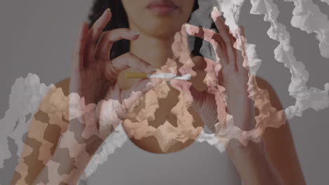 animación de una cadena de adn sobre una mujer biracial rompiendo un cigarrillo