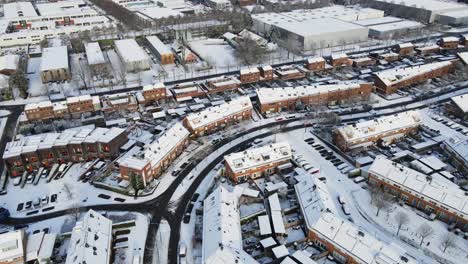 Aerial-of-cars-driving-trough-beautiful-suburban-neighborhood---drone-flying-backwards