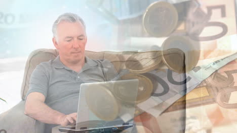 hombre de alto nivel usando una computadora portátil contra la caída de la moneda euro