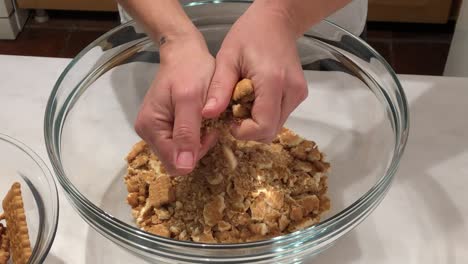 woman preparing biscuit cake in glass bowl