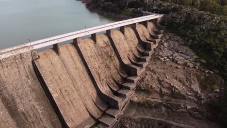 establisher view of dam with road on top, drought season, lowering, day