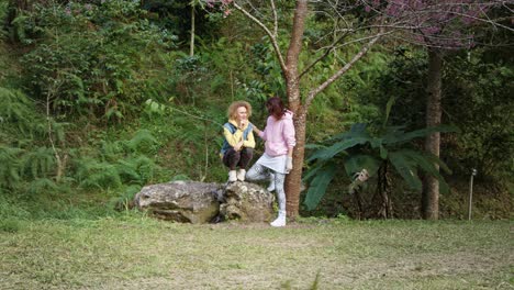 two women relaxing in a forest