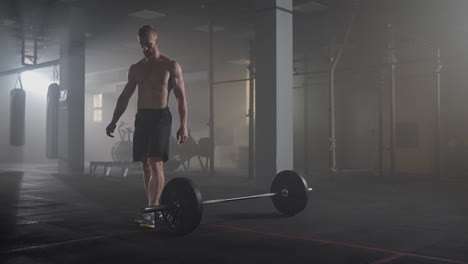 preparing for the exercise training. fitness man athlete chalk powder sportsman preparing training workout in gym ready for bodybuilding strength exercise slow motion.
