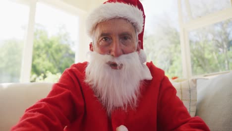 portrait of senior caucasian man at christmas time  wearing santa costume