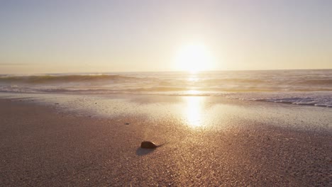 sunset and sea with waves and blue sky on empty sunny beach