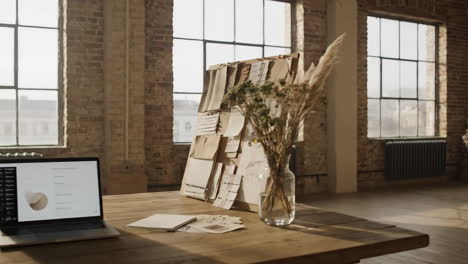 interior workspace with laptop and mood board
