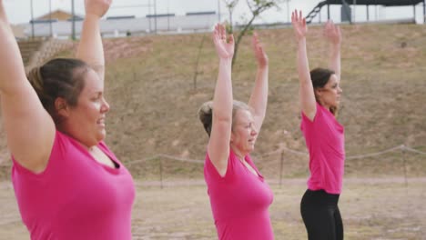 Female-friends-enjoying-exercising-at-boot-camp-together