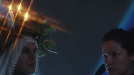 festively dressed couple in dark studio