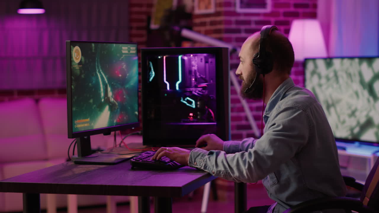 Handheld shot of gamer streaming fast paced space shooteron gaming pc setup while explaining gameplay