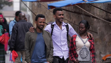 young friends walk and chat on a sidewalk in addis ababa, ethiopia