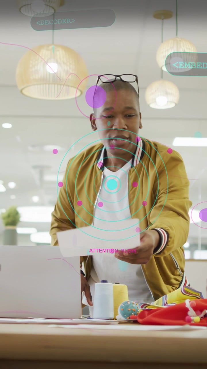Vertical video: Man leaning picking sheet, sorting samples for fashion review, overlays aligning