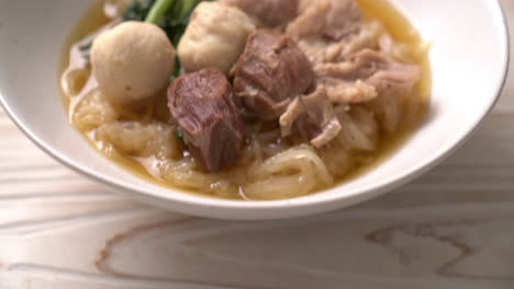 braised pork noodles bowl on table