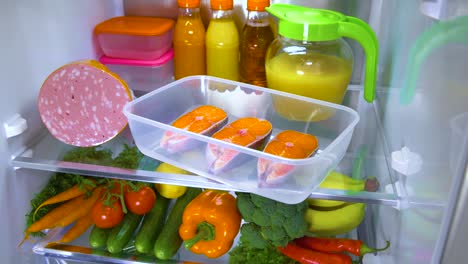 raw salmon steak in the open refrigerator