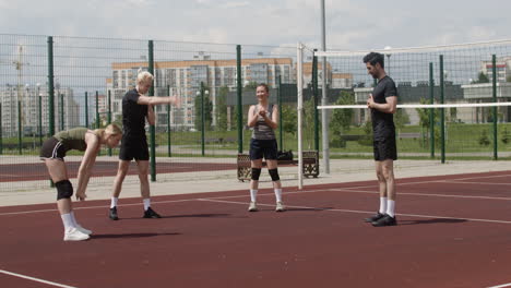 group of multiethnic friends in sportswear stretching