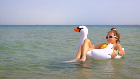 the child swims in a circle in the sea. selective focus.