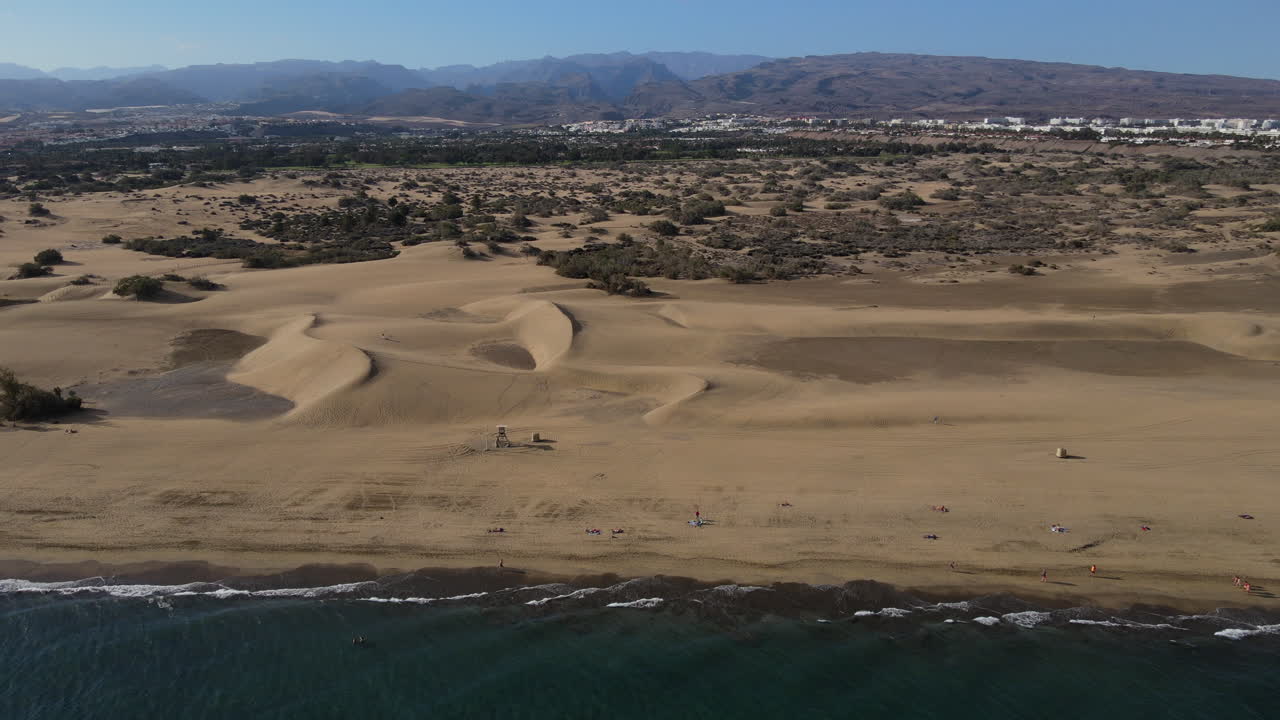 Aerial drone view, flying from the ocean to the beach