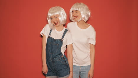 two happy friends in white wigs