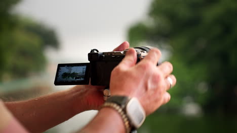 a man photographing the ideal view of trấn quốc pagoda in hanoi, vietnam - close up