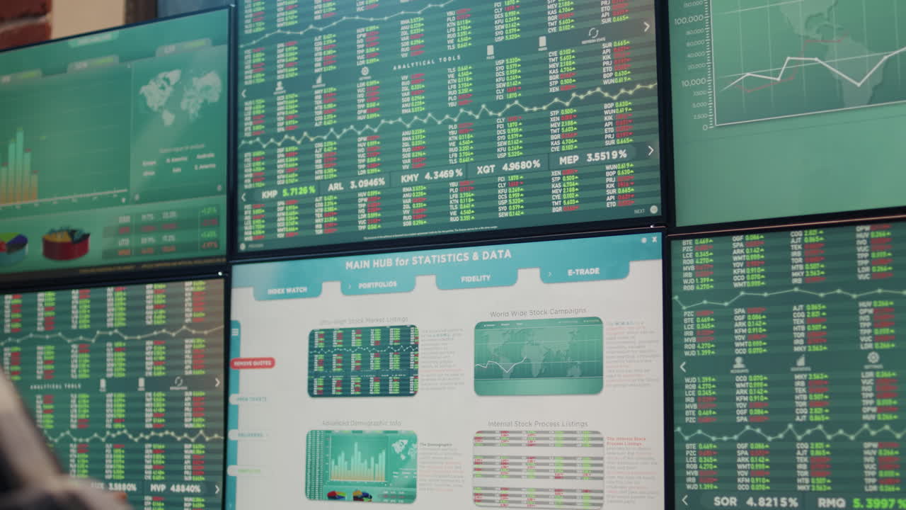 Male investor following sales market statistics on multiple monitors