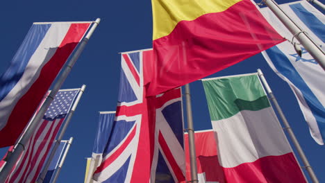 the vertical flag of the member states of the european union against a background of blue sky in baden-baden, germany - low angle shot