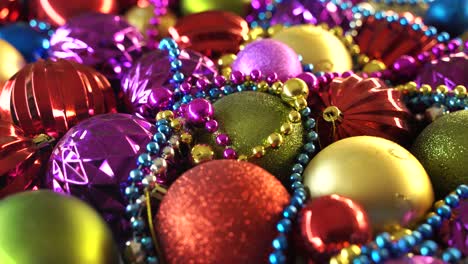 many colorful new year balls arranged on the table. merry christmas balls baubles decoration colors. close up