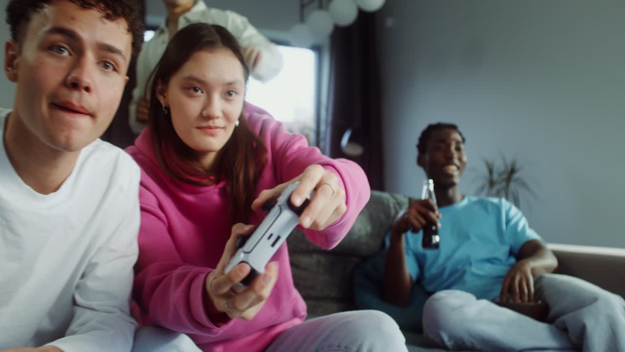 Friends having fun playing video games at home