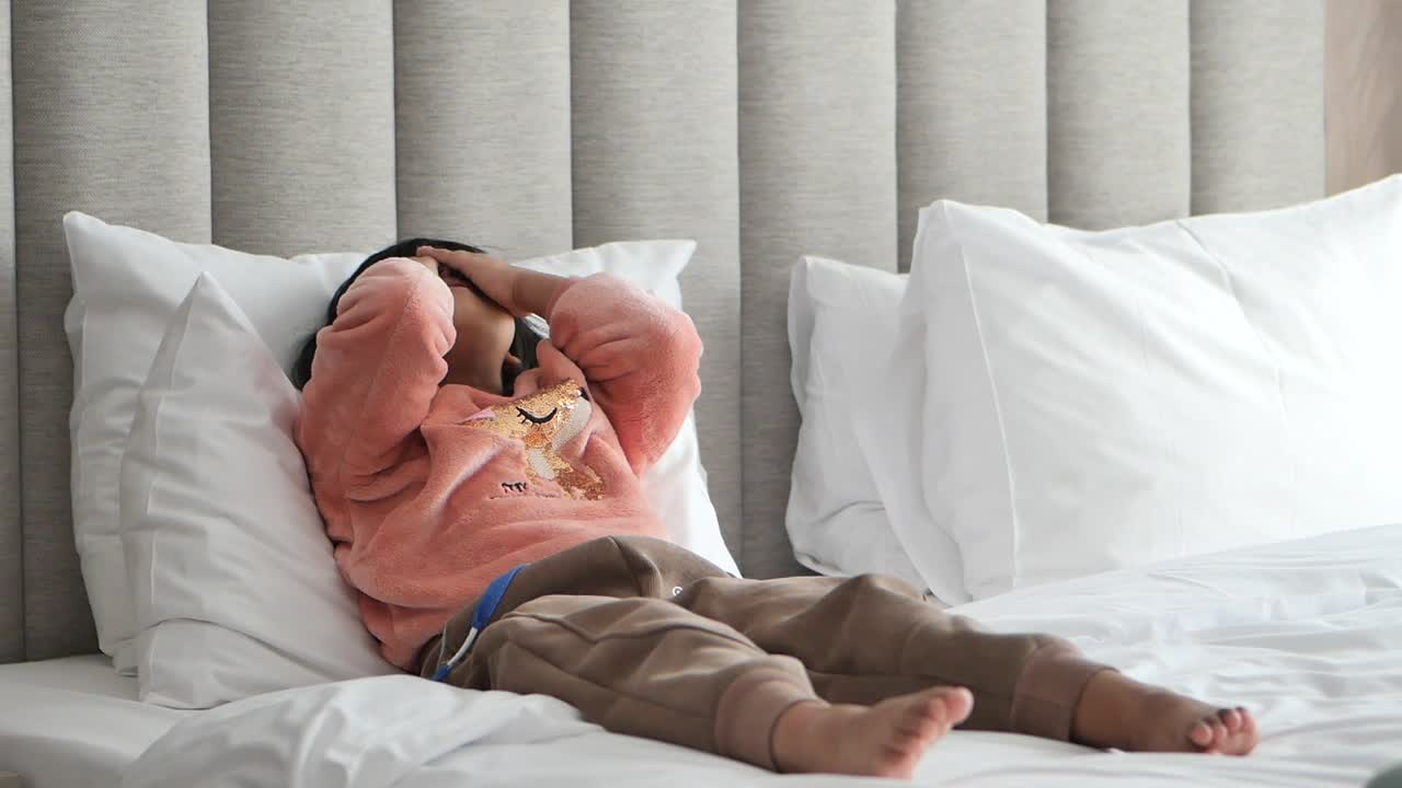 침대에 불행하게 누워있는 아이