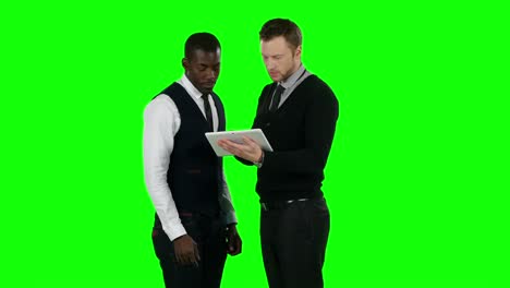 two businessmen discussing on a tablet