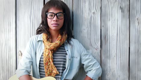 Smiling-hipster-woman-playing-guitar