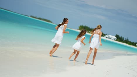 happy caucasian sisters outdoors together on tropical beach