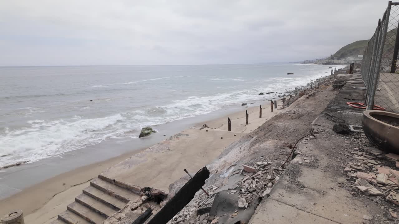 Gimbal wide panning shot of an oceanfront home burned by the Palisades Fire in Malibu, California. 4K